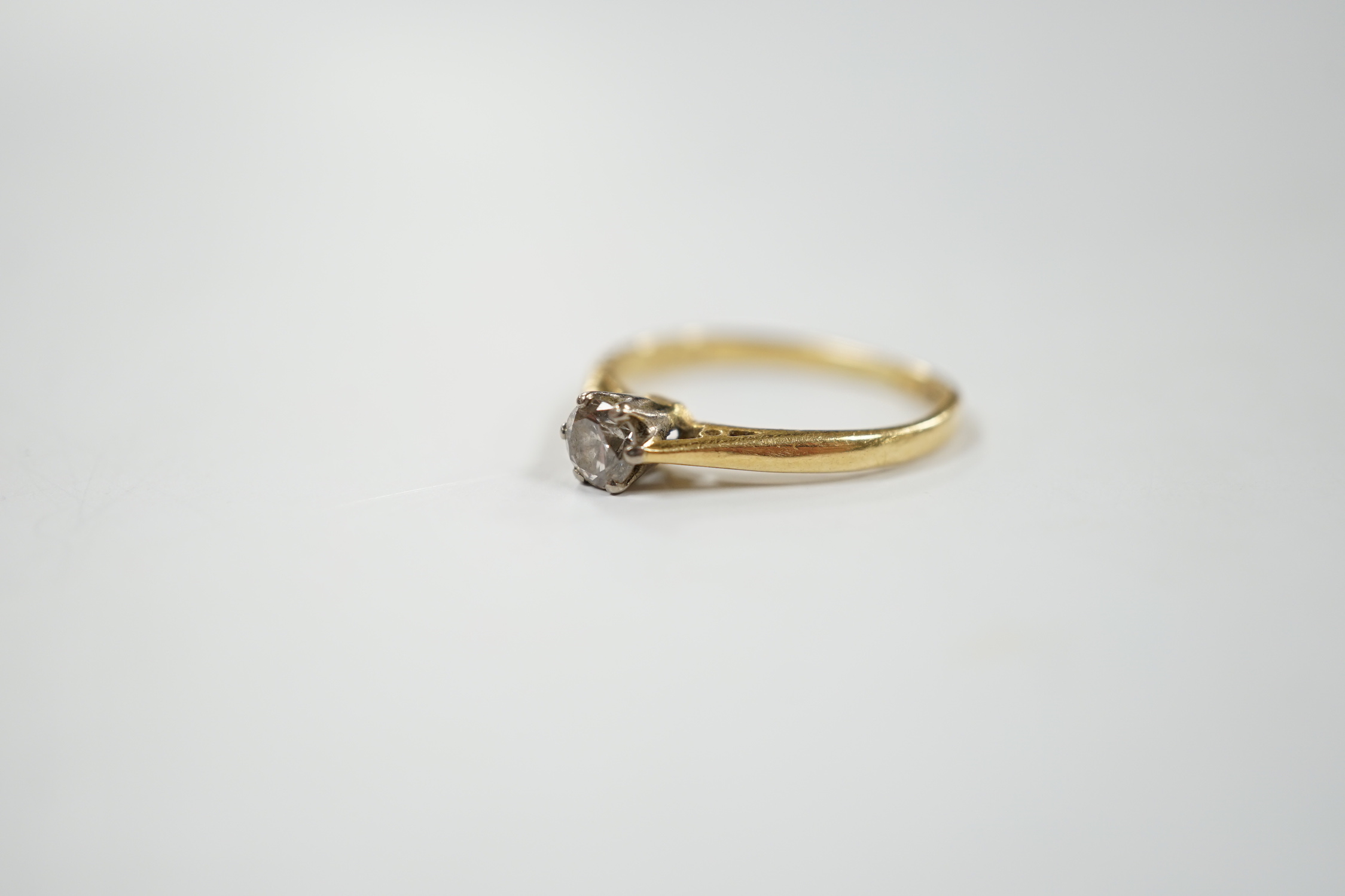 A modern 18ct gold and solitaire diamond set ring, size G/H, gross weight 1.8 grams.